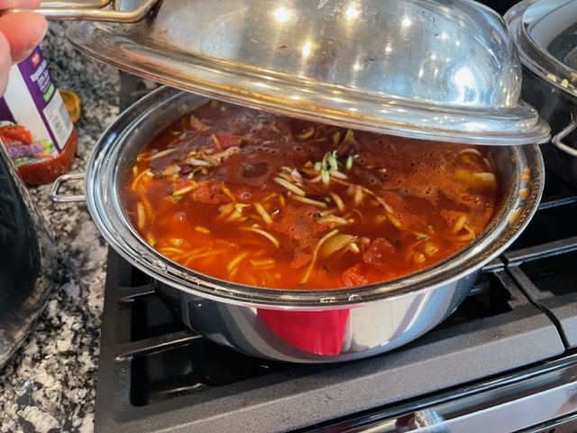 A red orange bowl of bean chili